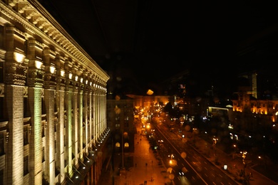 KYIV, UKRAINE - MAY 22, 2019: Beautiful view of illuminated Khreshchatyk street with road traffic and City Council building