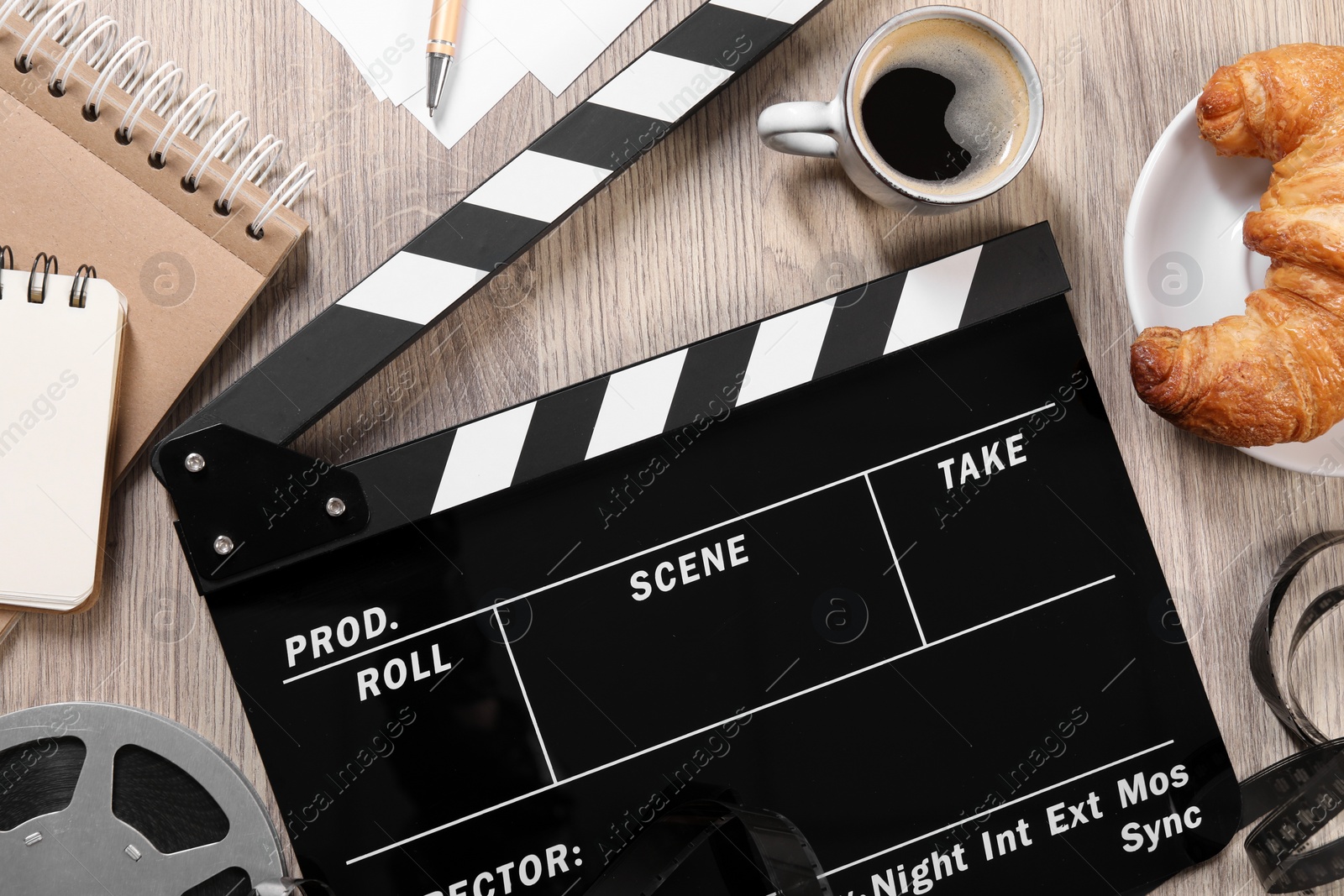 Photo of Flat lay composition with movie clapper on wooden table