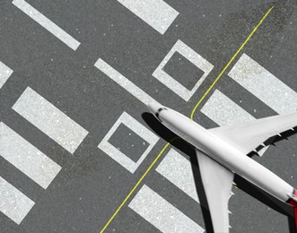 Image of Modern white airplane landing on runway, top view