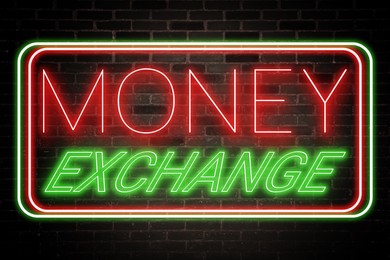 Money Exchange neon sign on brick wall. Bright frame with text