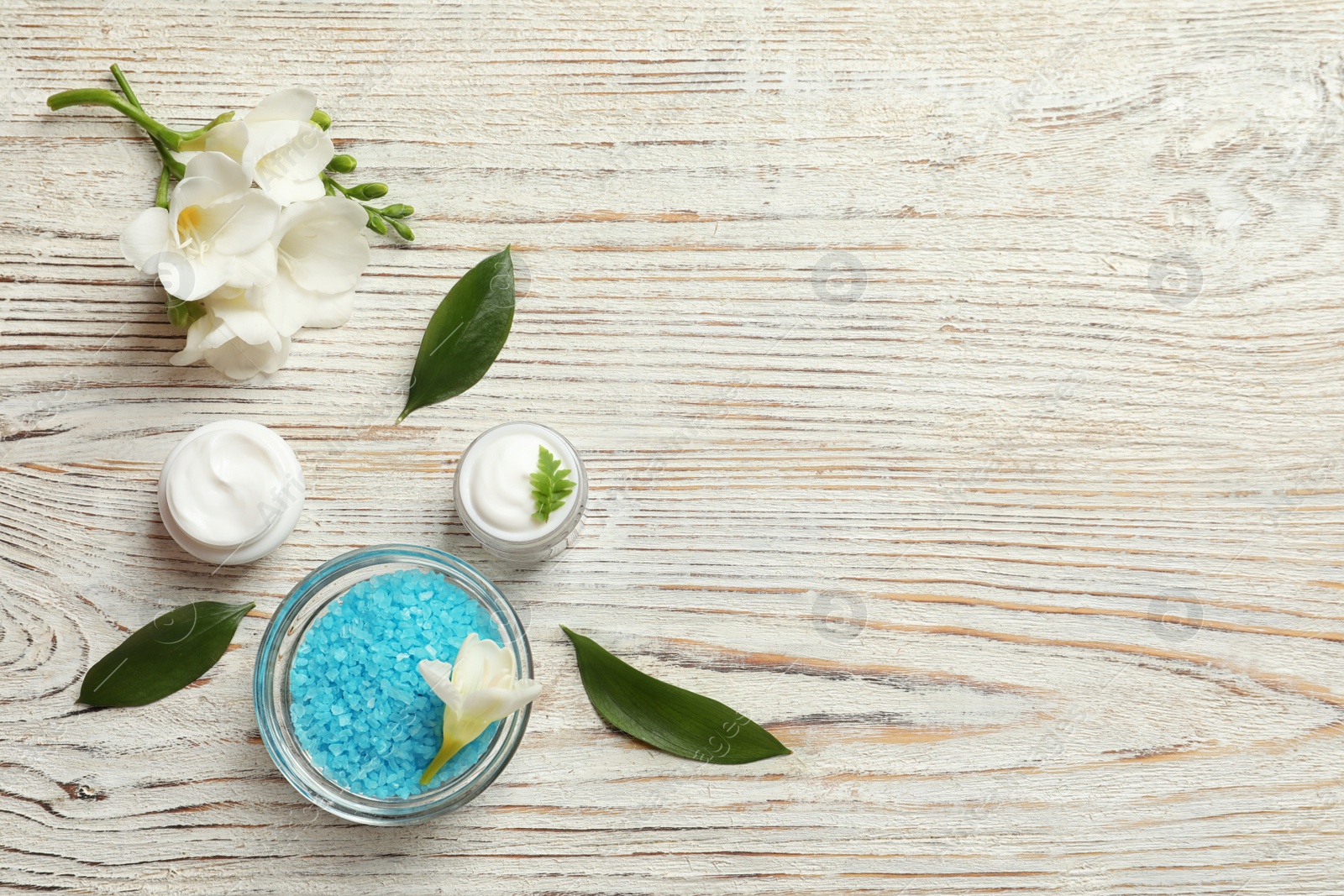 Photo of Flat lay composition with cosmetic products on wooden background