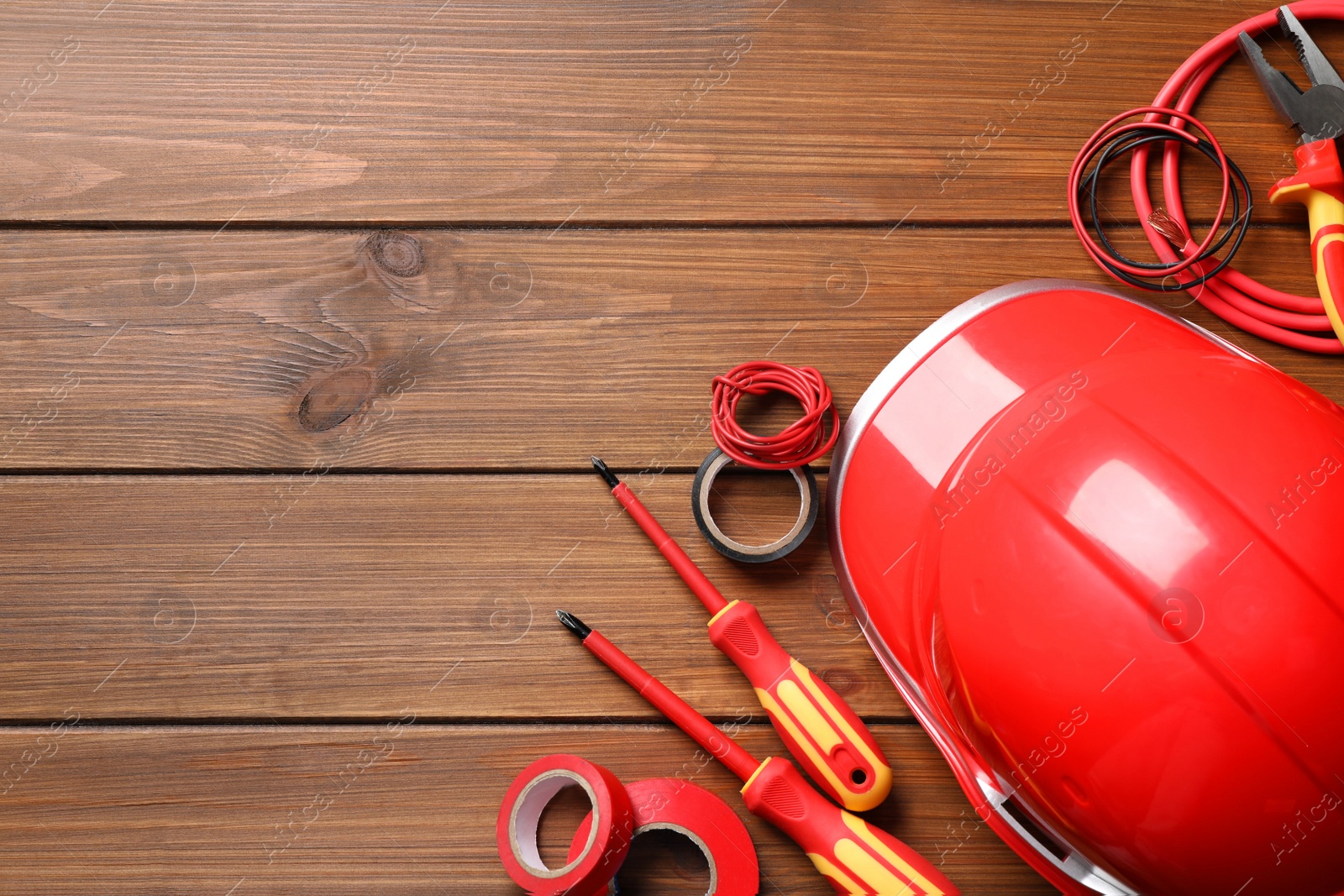 Photo of Flat lay composition with electrician's tools and accessories on wooden background, space for text