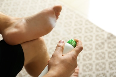 Man using medicine for prevention fungal infection indoors, closeup