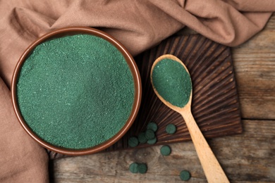 Photo of Flat lay composition with spirulina algae powder on wooden background