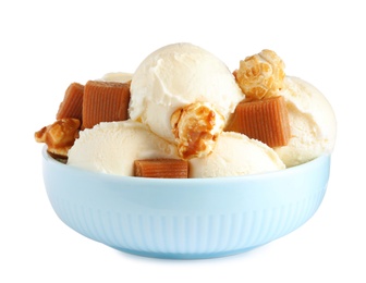 Plate of delicious ice cream with caramel candies and popcorn on white background