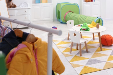 Child`s playroom with different toys and modern furniture. Stylish kindergarten interior