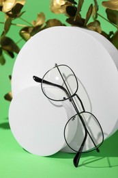 Photo of Stylish presentation of glasses on green background