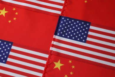 Photo of USA and China flags as background, top view. International relations