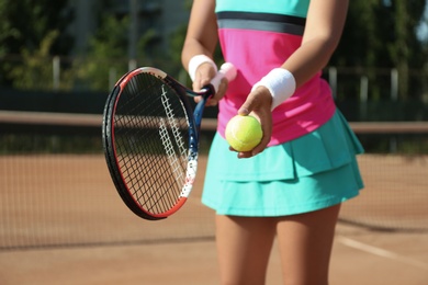 Sportswoman preparing to serve tennis ball at court, closeup