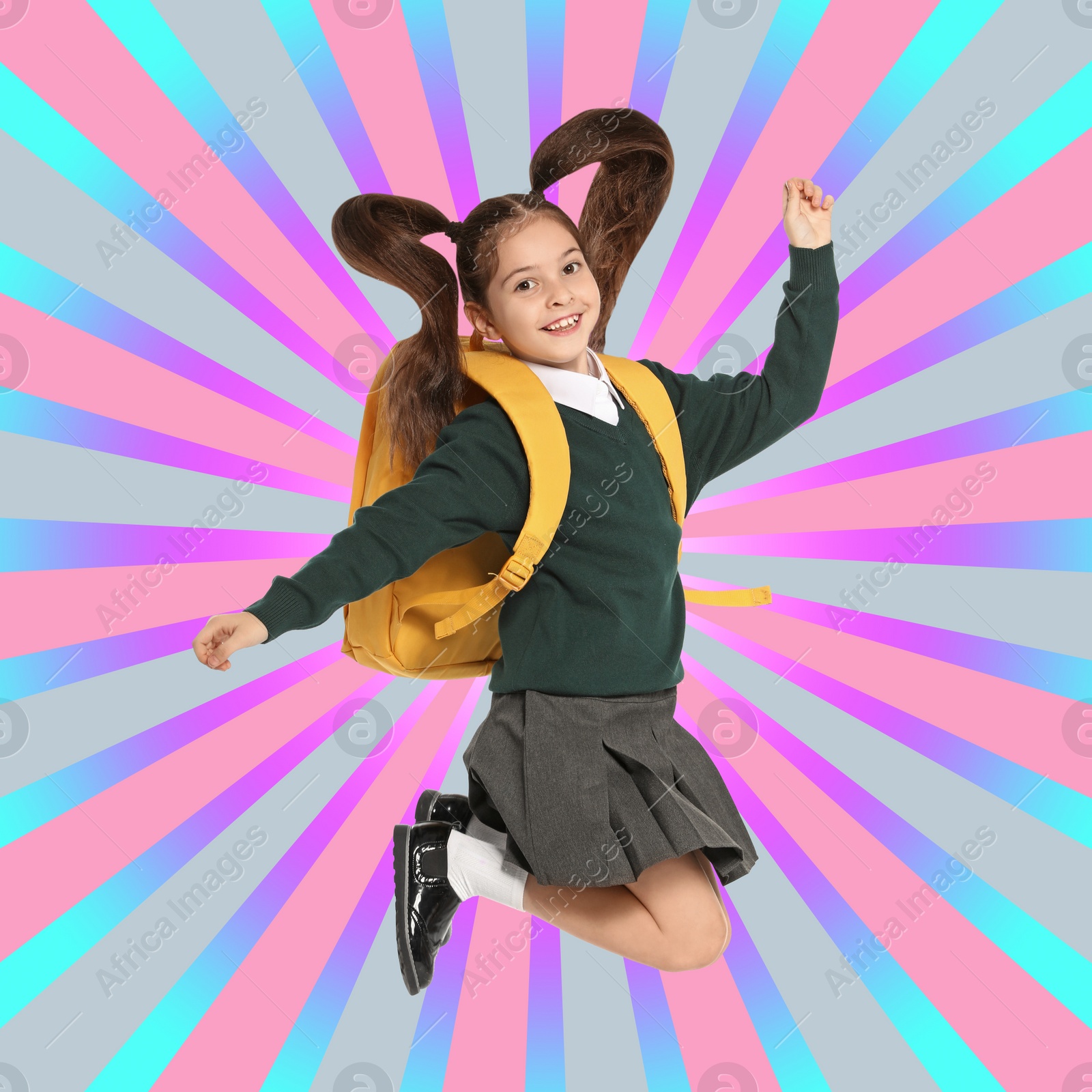 Image of Little girl jumping on colorful background. School holidays