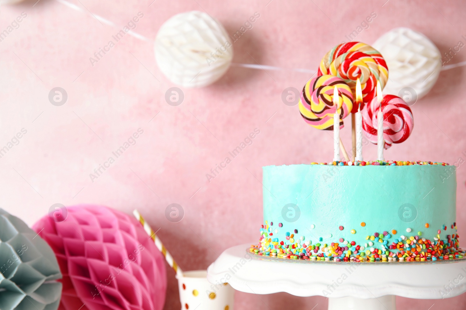 Photo of Stand with fresh delicious cake and birthday decorations on color background. Space for text