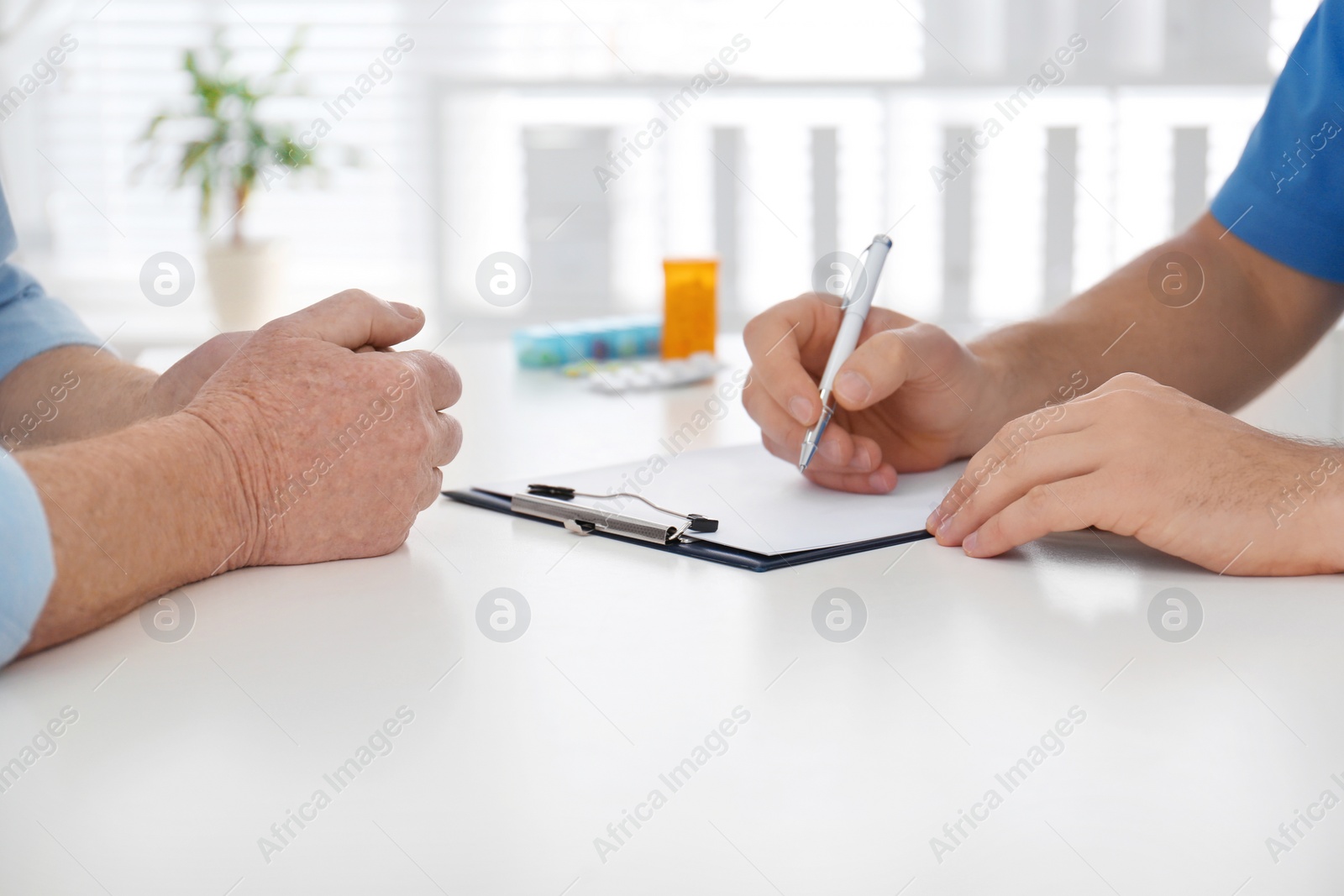 Photo of Professional doctor examining senior patient in office, closeup