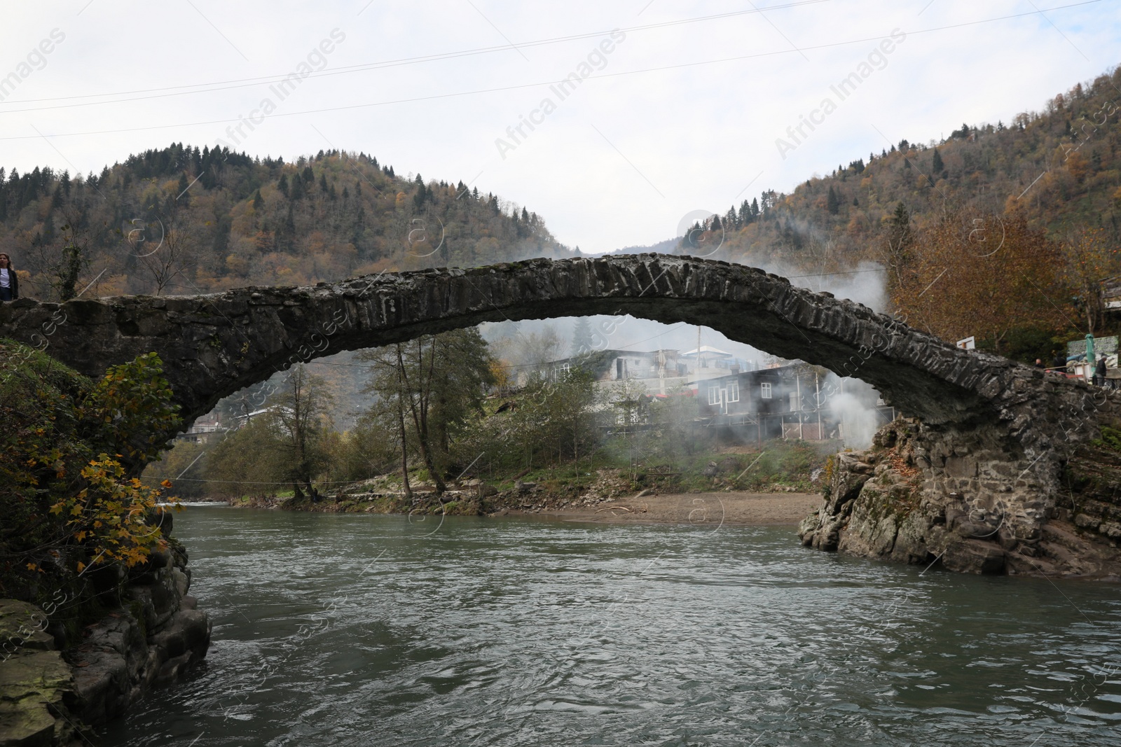 Photo of Adjara, Georgia - November 19, 2022: Picturesque view of stone arched bridge over Acharistskali river in mountains