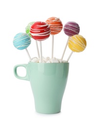 Photo of Delicious colorful cake pops in cup on white background