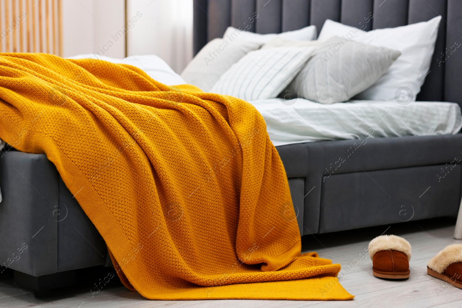 Photo of Bright plaid on bed in stylish bedroom