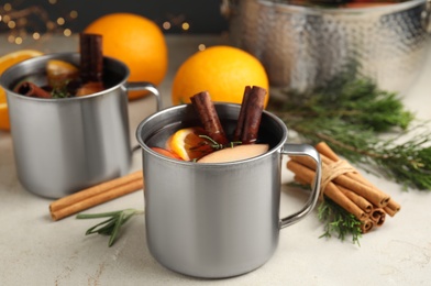 Tasty mulled wine with spices on light table