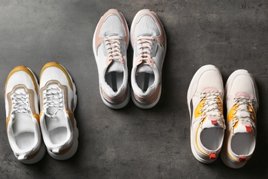 Photo of Flat lay composition with sneakers on grey background. Stylish shoes
