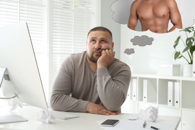 Overweight man dreaming about muscular body at table in office. Weight loss concept