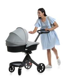 Happy young woman with baby stroller on white background