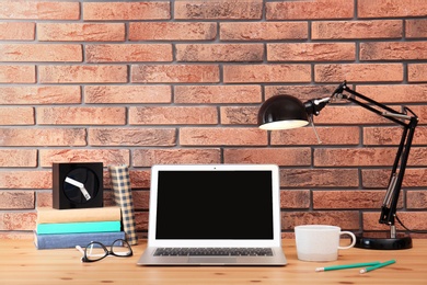 Laptop on table in home office. Mockup with space for text