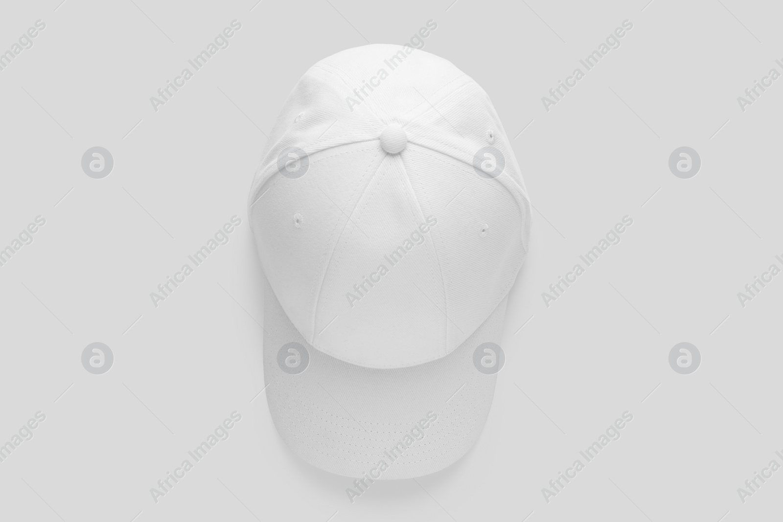 Photo of Stylish baseball cap on white background, top view