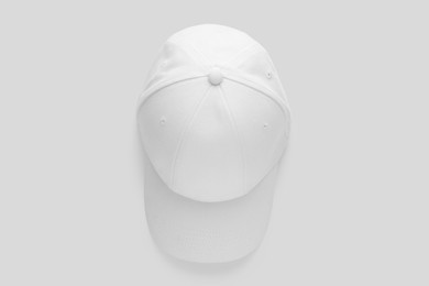 Photo of Stylish baseball cap on white background, top view