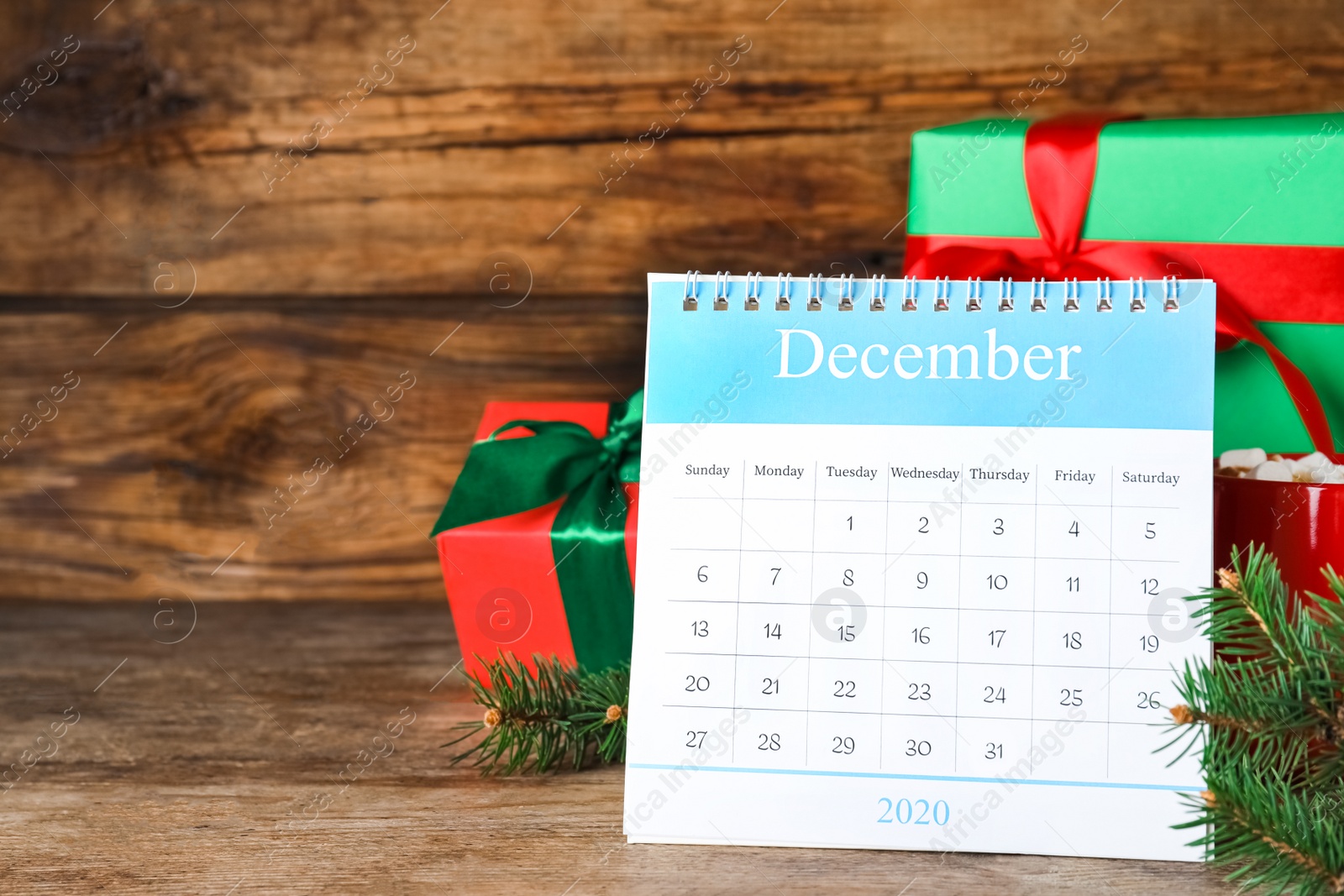 Photo of Flip calendar and Christmas decor on wooden table. Holiday countdown