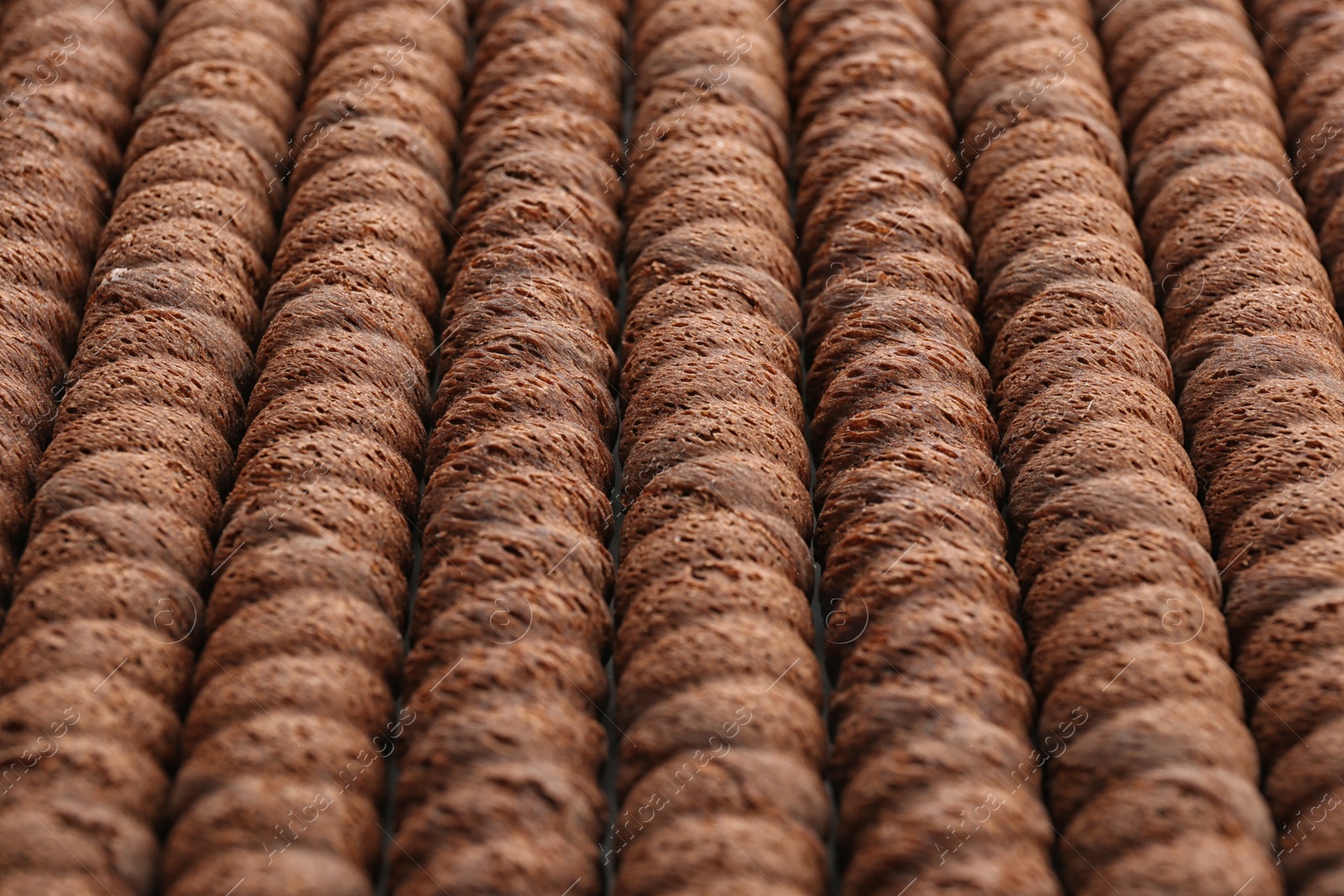 Photo of Delicious chocolate wafer rolls as background, closeup. Sweet food