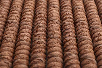 Delicious chocolate wafer rolls as background, closeup. Sweet food