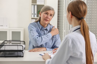 Arthritis symptoms. Doctor consulting patient with shoulder pain in hospital