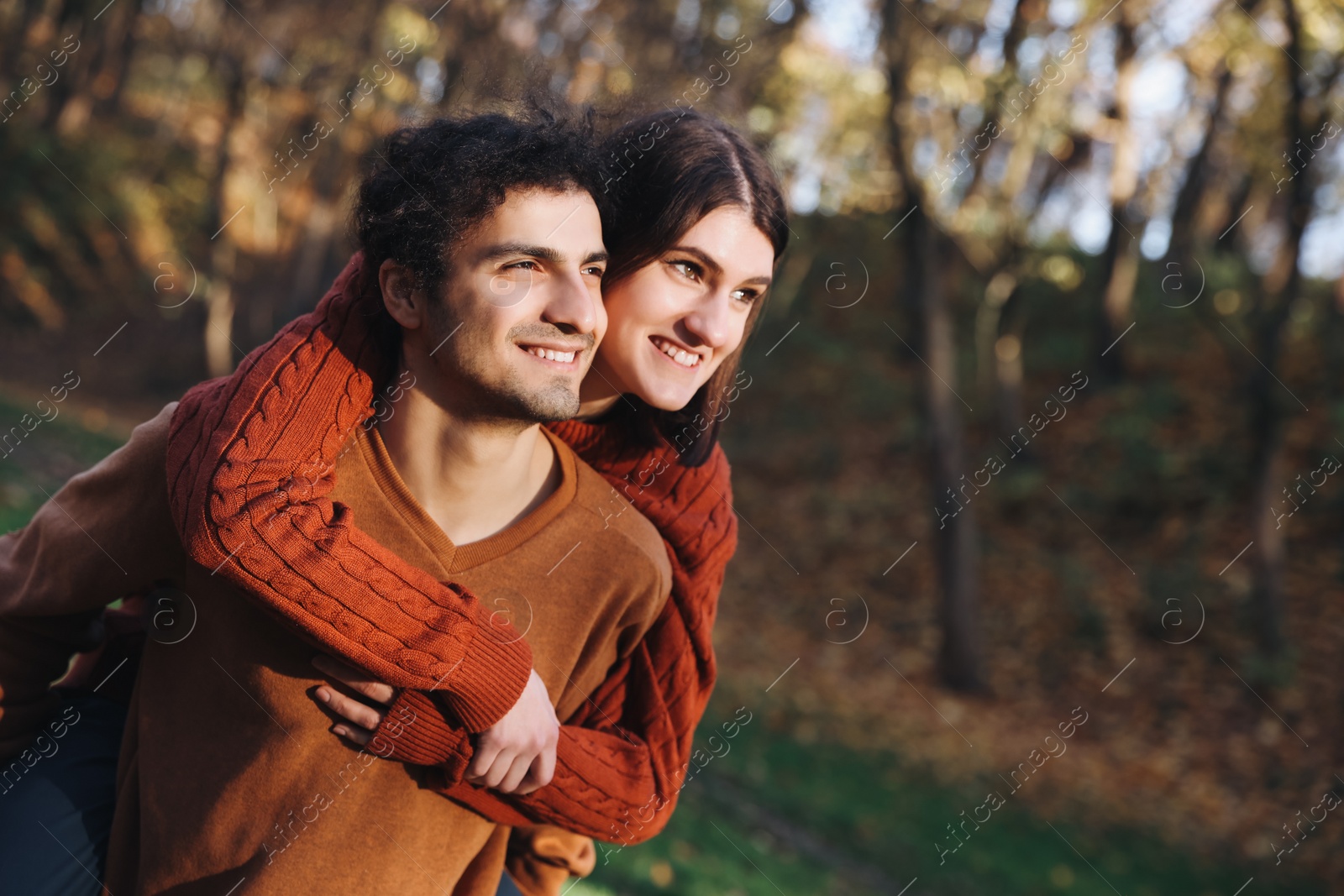 Photo of Happy young couple spending time together in autumn park, space for text. Dating agency