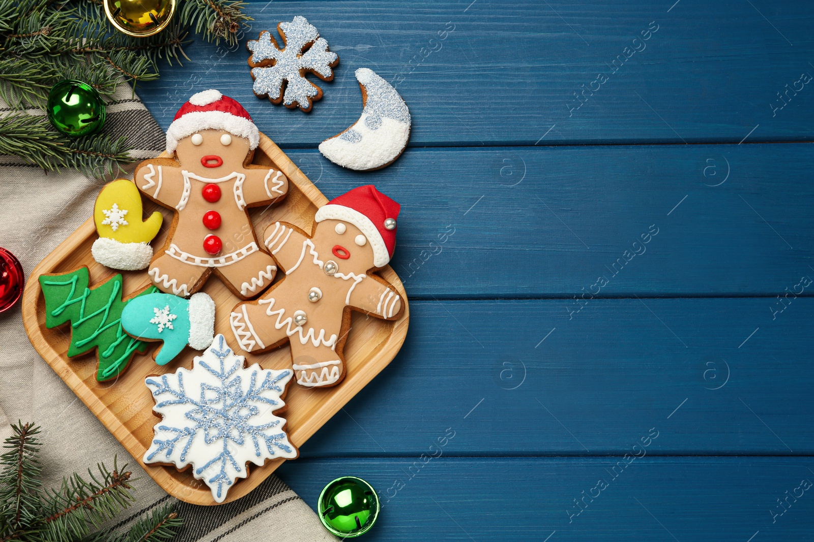 Photo of Flat lay composition with delicious Christmas cookies on blue wooden table, space for text