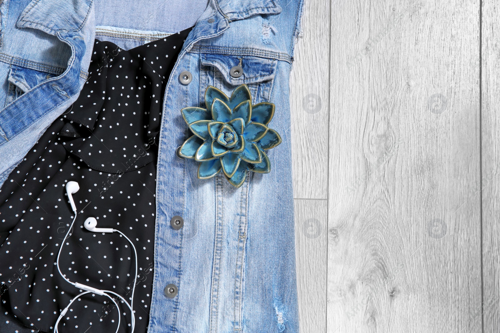 Photo of Set of trendy female clothes and accessories on wooden background, flat lay