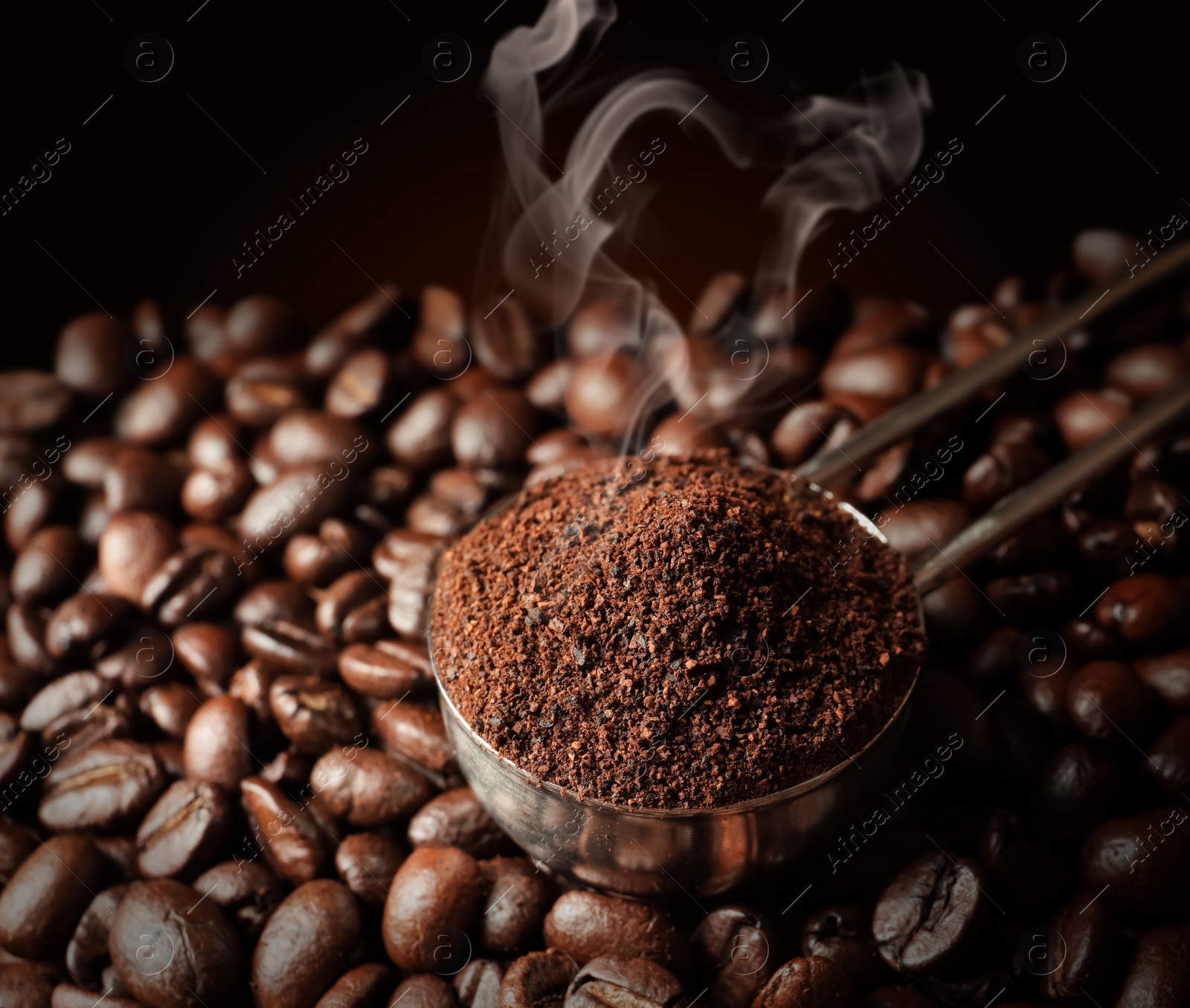 Image of Spoon with coffee grounds and roasted beans, closeup