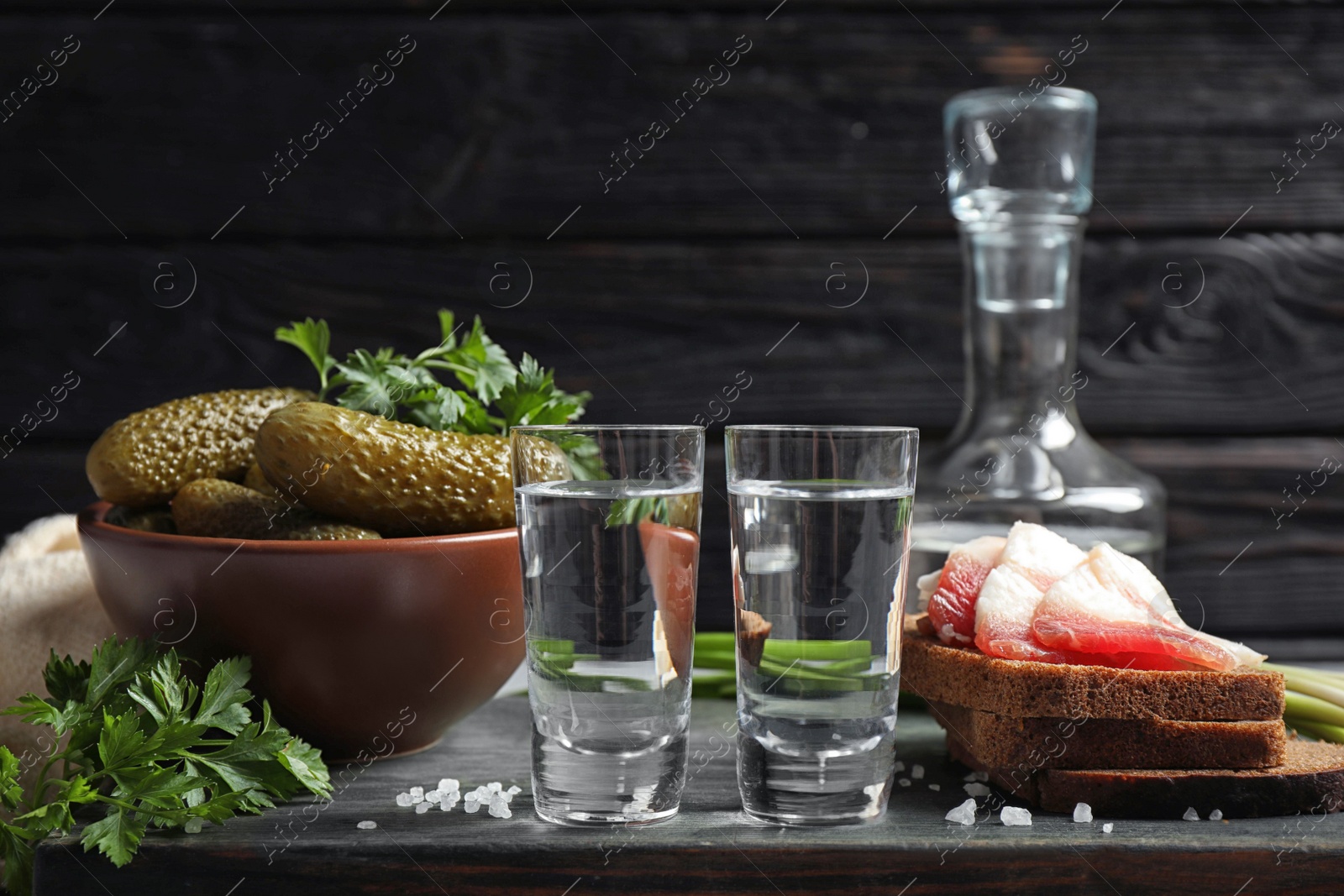 Photo of Cold Russian vodka with snacks on table