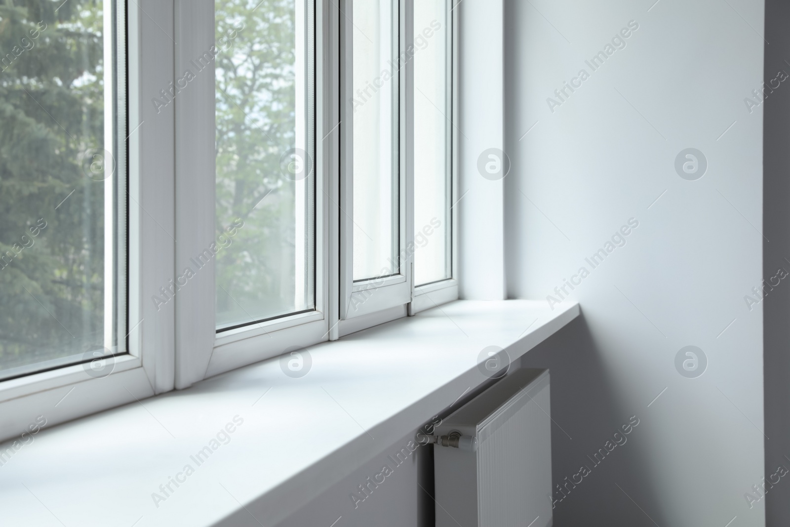 Photo of Modern office with window and radiator. Interior design