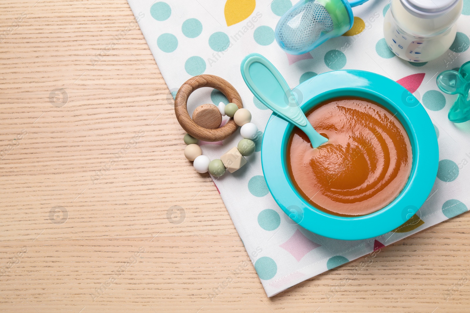 Photo of Flat lay composition with healthy baby food on wooden table, space for text