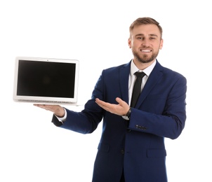 Happy young businessman holding laptop with empty screen on white background, space for text