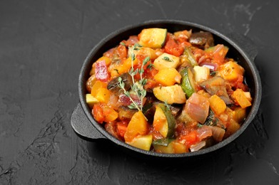 Dish with tasty ratatouille on black table