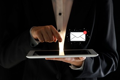 Image of Email. Man using tablet against black background, closeup. Incoming letter notification over device