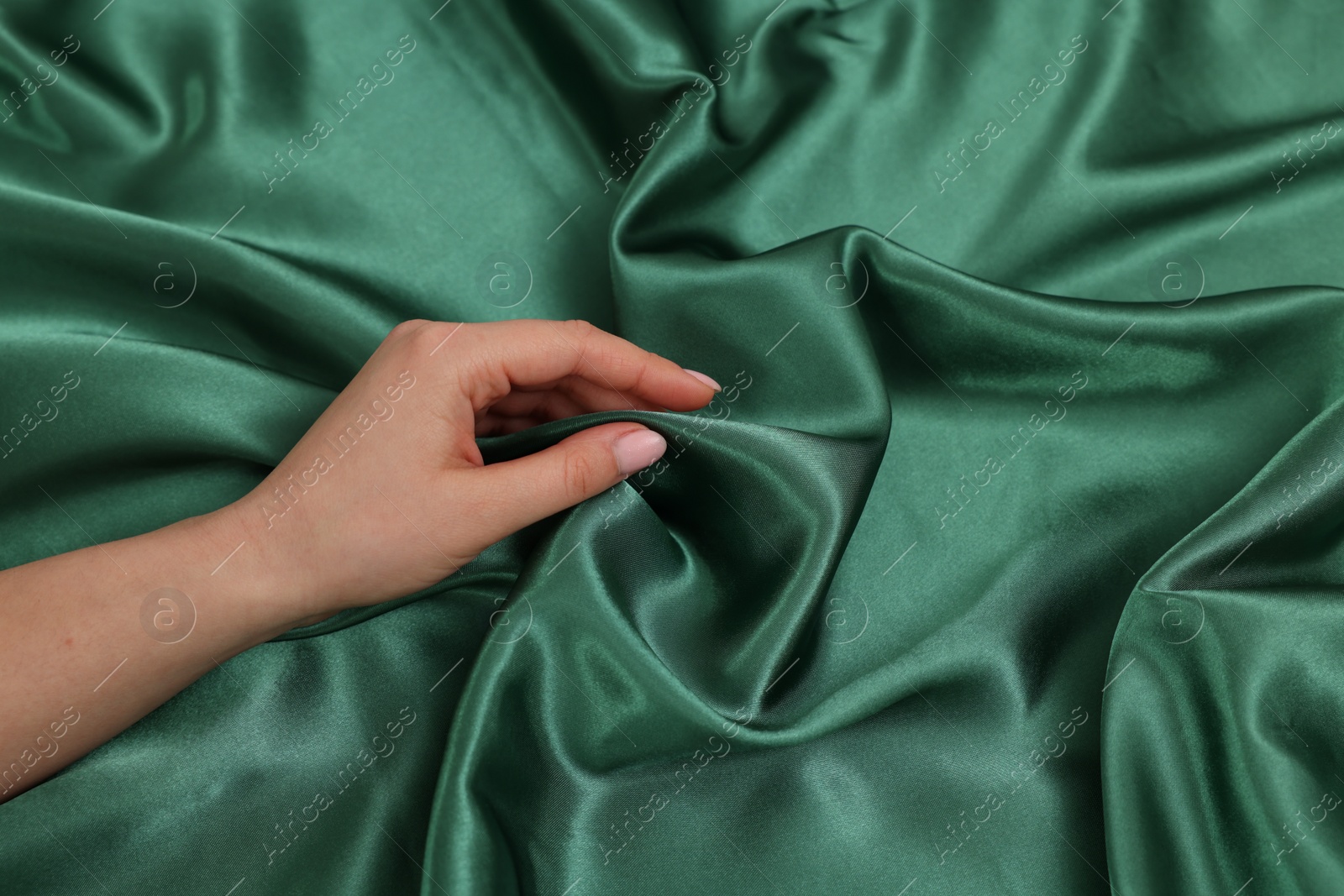Photo of Woman touching smooth silky fabric, closeup view