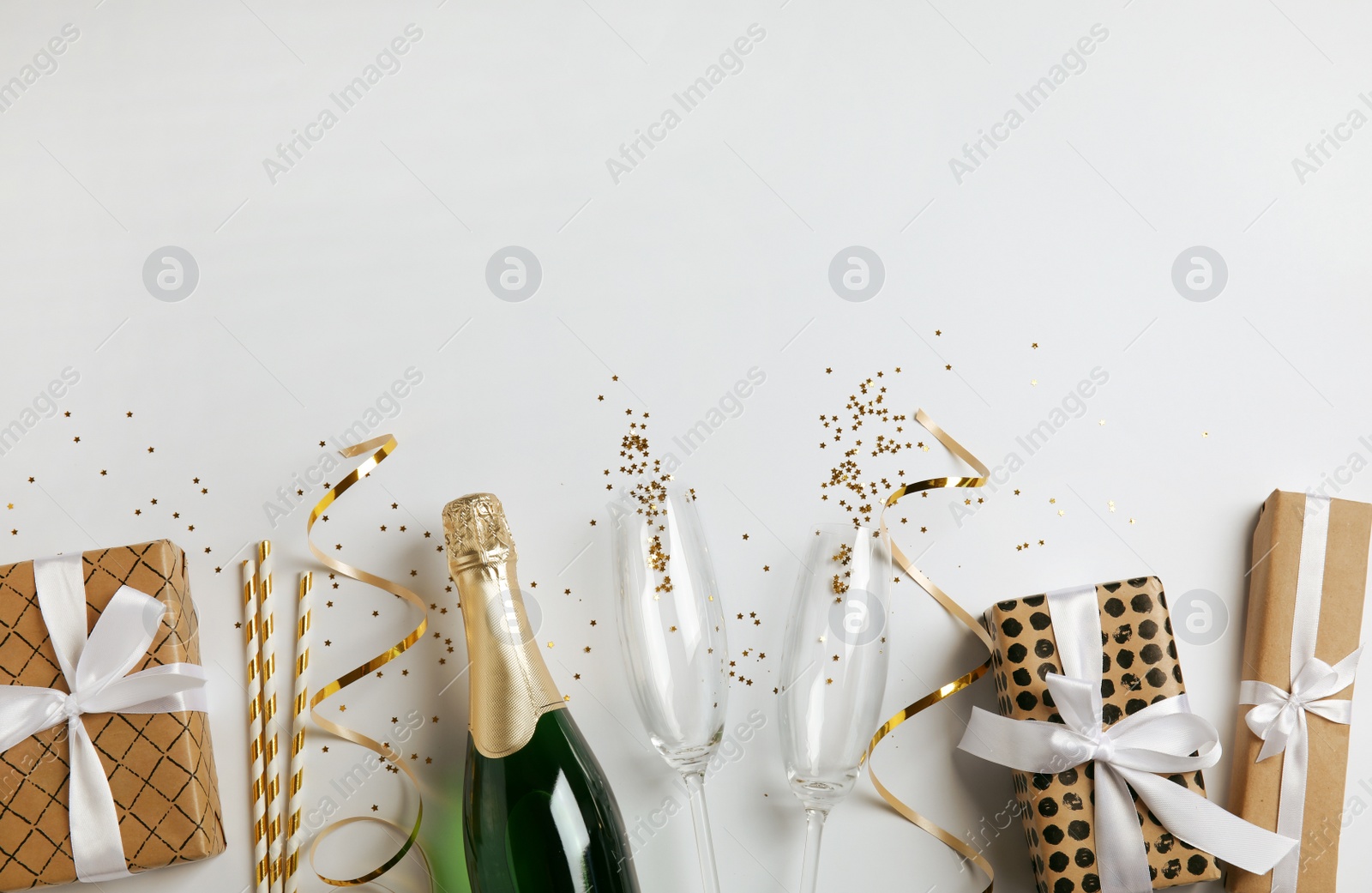 Photo of Creative flat lay composition with bottle of champagne and space for text on white background