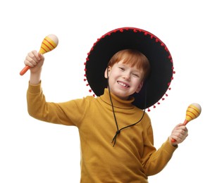 Cute boy in Mexican sombrero hat dancing with maracas on white background