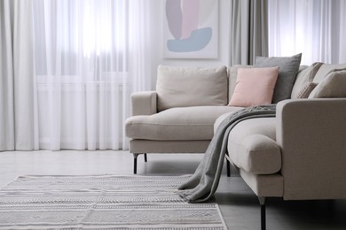 Comfortable sofa in stylish living room interior