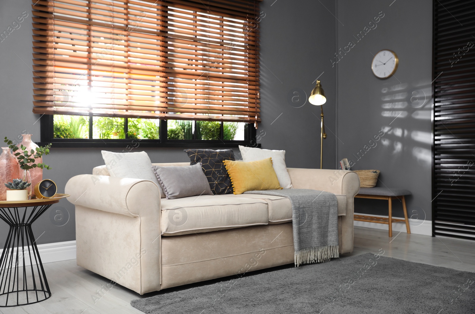 Photo of Stylish living room interior with comfortable sofa near window