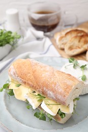 Tasty sandwich with brie cheese served on table