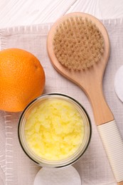 Photo of Natural body scrub, orange and brush on white wooden table, flat lay. Anti cellulite treatment