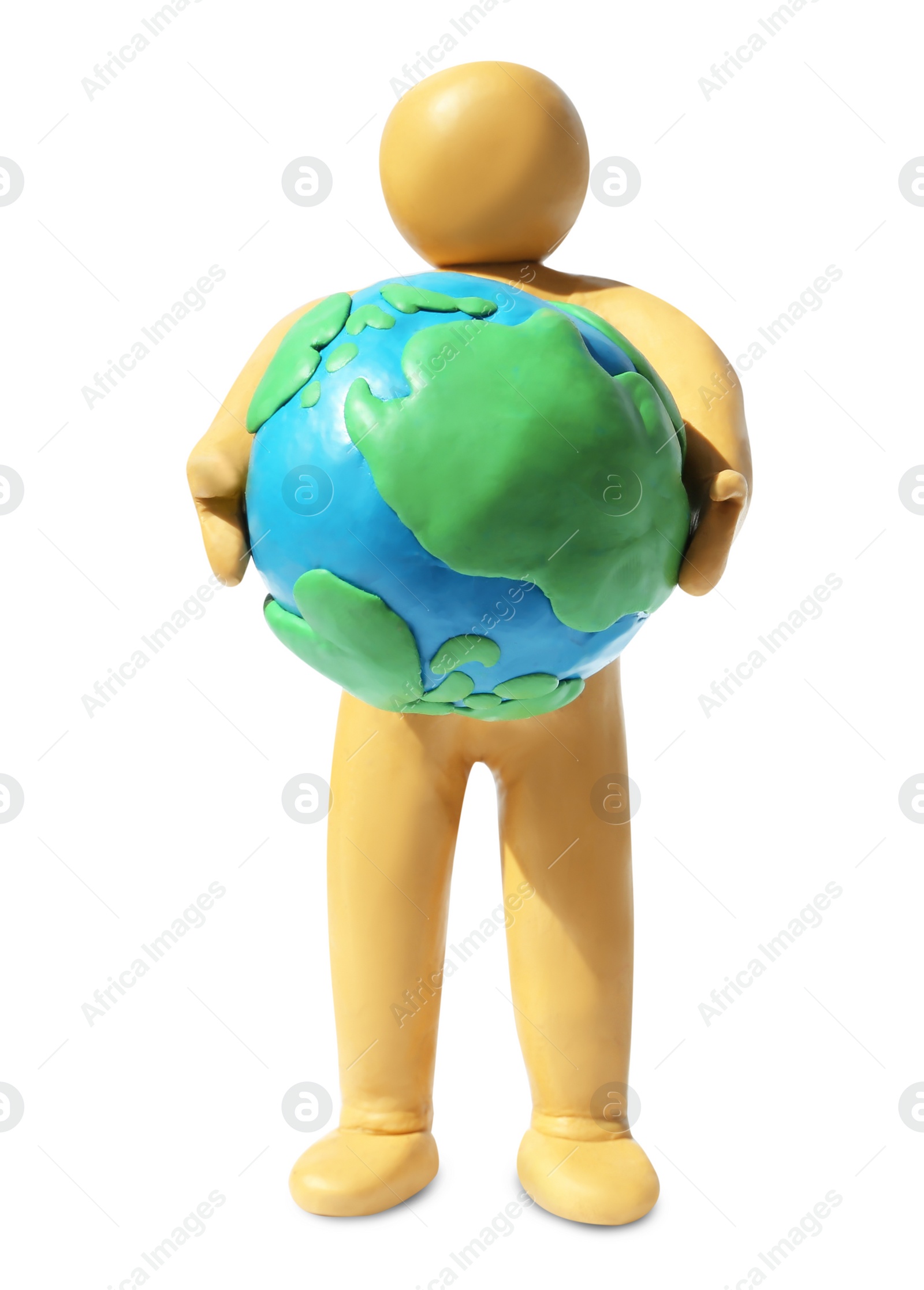 Photo of Yellow plasticine human figure holding planet isolated on white