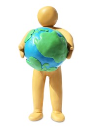 Photo of Yellow plasticine human figure holding planet isolated on white