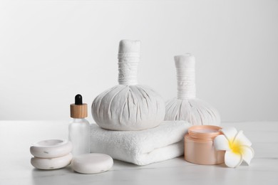 Photo of Spa composition with care products on white marble table